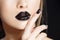 Beautiful Fashion woman model face portrait with black lipstick and nails. Glamour girl with bright makeup. Beauty