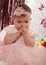 Beautiful fashionable little baby in pink dress. little princess poses like a doll