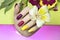 Beautiful fashionable multi-colored manicure with matte and glossy nail Polish colors with decorative small flowers