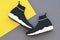 Beautiful fashionable socks sneakers on a yellow-gray background