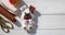 A beautiful felt puppy with a brown ear and muzzle, with a bone and a red heart on a white boards background