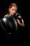 Beautiful female athlete in boxing gloves, in the studio on a black background. Focus on the glove