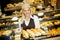 Beautiful female bakery posing with various types of sandwiches