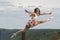 Beautiful female ballerina or dancer leaps outdoors