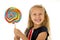 Beautiful female child with long blond hair holding huge spiral lollipop candy smiling happy