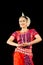 Beautiful Female Classical Odissi dancer performing Odissi Dance on stage in special attire at Konark Temple, Odisha, India.