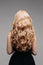 Beautiful female curly blond hairs - back view