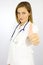 Beautiful female doctor thumb up serious