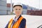 Beautiful female engineer looking away in shipping yard