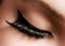 Beautiful female eye with extreme long eyelashes, black liner makeup. Perfect make-up, long lashes. Closeup fashion eyes