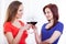 Beautiful female friends raising glasses of red wine