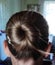 Beautiful female hairstyle, a bump of hair on the head, hair tied in a bump