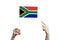 A beautiful female hand holds a South African Republic flag to which she shows the finger of her other hand, isolated on white