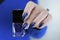 beautiful female hand with long nails and purple blue manicure