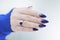 beautiful female hand with long nails and purple blue manicure