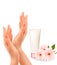 Beautiful female hands with a cream and flowers.