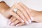 Beautiful female hands with diamond ring with pearl. Beautiful woman`s nails with manicure. Diamond ring with pearl.