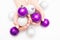 Beautiful female hands with stylish nail manicure polish on winter Christmas balls white background, top view. Skin care