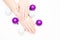 Beautiful female hands with stylish nail manicure polish on winter Christmas balls white background, top view. Skin care