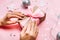 Beautiful female hands with trendy manicure holding gift box on festive christmas background.