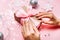 Beautiful female hands with trendy manicure holding gift box on festive christmas background