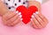 Beautiful female hands with white manicure, hearts design