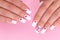 Beautiful female hands with white manicure, hearts design