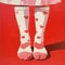 Beautiful female legs in socks with a hearts print. Retro fashion, vintage concept