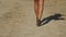 Beautiful female legs step on a dusty road