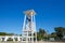 Beautiful female lifeguard stands on a tower