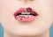 Beautiful female lips closeup. Perfect female mouth with glitter lipstick makeup, pink tint and white teeth