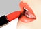 Beautiful female lips with fashion make-up. Trend light coral color. Makeup, visage and cosmetics. Choice lipstick