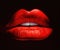 Beautiful female lips painted in red on a black background
