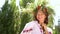 Beautiful female model in floral circlet and embroidered dress posing outside