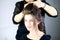 Beautiful female model getting hair done by professional hairstylist