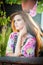 Beautiful female portrait with long red hair outdoor. Genuine natural redhead with bright colored blouse in park. Portrait