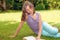 Beautiful female teenage reading a book on the grass