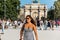 A beautiful female tourist in front of the Arc de Triomphe du Carrousel, situated at the entrance of Jardin de Tuileries, close to