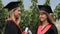 Beautiful females graduates discussing future plans after receiving diplomas