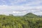 Beautiful fertile forest countryside of thailand. Sunny afternoon. Tree, sky and rolling hills. Rural scenery. View of the forest