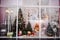 Beautiful festive Christmas storefront with decorated artificial Christmas trees and toys