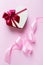 Beautiful festive image with a heart-shaped box and a silk ribbon on a pink background