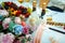 Beautiful festive table for the newlyweds, close-up. Champagne bottles are decorated with lace. Flowers, glasses, snacks, fruit