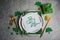 Beautiful festive table setting for St.Patricks day with cutlery and lucky symbols. Copy spase in center. Flat lay