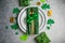 Beautiful festive table setting for St.Patricks day with cutlery and lucky symbols. Copy spase in center. Flat lay