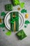 Beautiful festive table setting for St.Patricks day with cutlery and lucky symbols. Copy spase in center. Flat lay