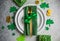 Beautiful festive table setting for St.Patricks day with cutlery and lucky symbols. Copy spase in center. Flat lay