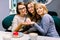 Beautiful fiancee. Nice happy woman posing for a photo while showing her engagement ring together with her two women