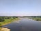 Beautiful field scenery with river and bridge. Poland