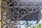 Beautiful filigree patterns of a wrought iron canopy over the porch.